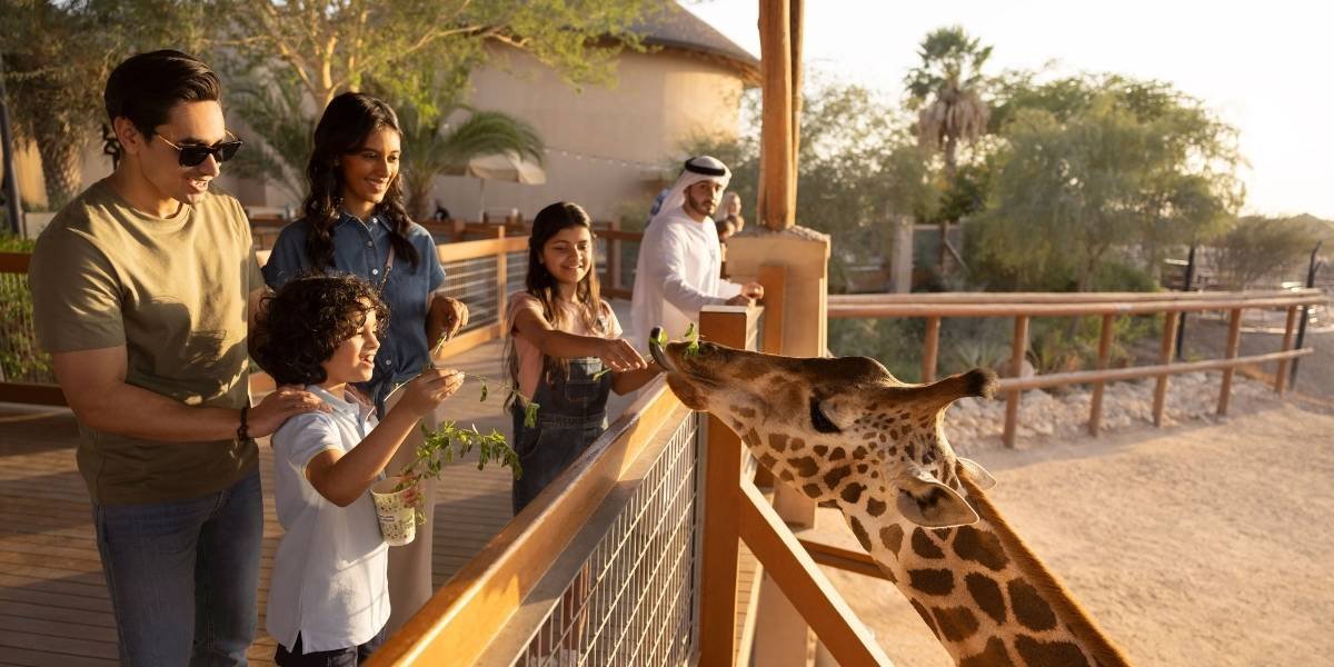 Giraffes and visitors at Al Ain Zoo Abu Dhabi